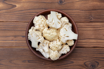 Organic cauliflower on wooden background