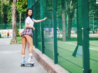 beautiful sexy girl with long legs wis a skateboard