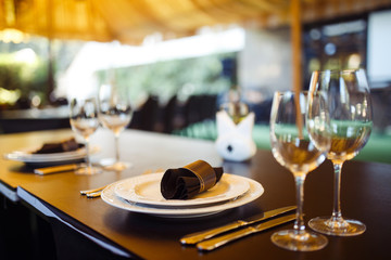 Sparkling glassware stands on long table prepared for wedding dinner