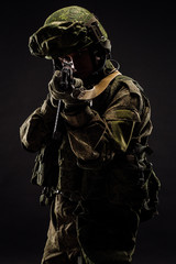 russian special forces soldier with rifle on dark background. army, military and people concept
