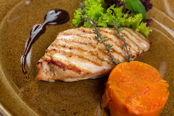 Grilled chicken fillet on plate