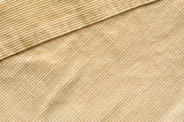 Fototapeta premium Texture of Beige Velvet Clothes with Stitches. Seams on Cloth. Textile Fabric of Corduroy as Background