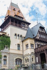 Fototapeta na wymiar Historic building in Romania. Medieval castle in Europe. Architecture of the Middle Ages. An old house. Luxury estate. An old house. Peles Castle.