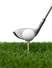 Golf Ball on Tee and Club on Golf Course