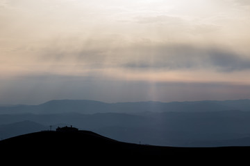 View of Serrasanta hermitage (Umbria, Italy) on top of a mountain, with various others mountains layers in the background