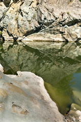 rocks that are reflected in the water
