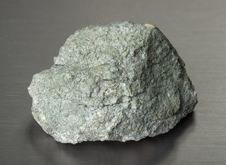Specimen of sulfur pyrite (iron pyrite) mineral on gray background