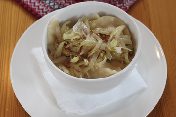 Dumplings with cabbage and fried onions