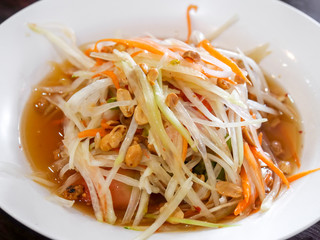 Papaya salad on white  dish.