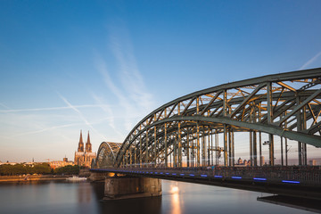 Cologne Cathedral and Bridge to Deutz (Hohenzollern Bridge) against blue sky