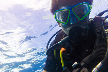Scuba diving man with mask and underwater wetsuit take selfies photo