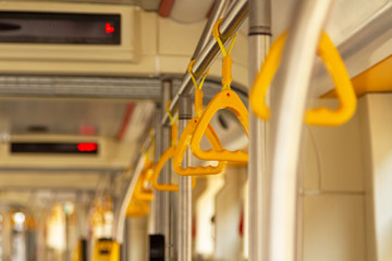 Yellow handles at municipal transport. Handles for sustainability in public transport. Handles in the municipal trolley, bus, tram. Grips in the municipal trolley, bus, tram. Yellow grips.