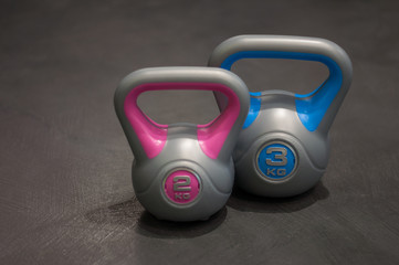 health and sport lifestyle concept, two several plastic weights of different weights and colors