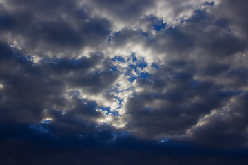 Fototapeta premium View on beautiful white and gray clouds in a blue sky. Clouds and Skies in the afternoon. The Sun behind Clouds. Fresh Air. Cloudy Weather. Cloud Formations...