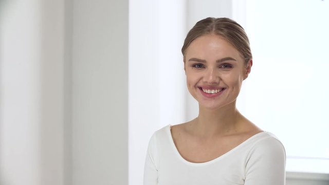 Portrait Of Happy Woman With Natural Beauty In White Interior