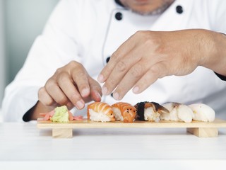 Obraz na płótnie Canvas Close up master chef making sushi in restaurant.
