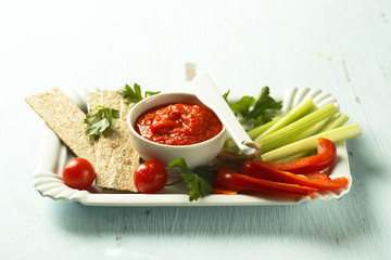 Roasted pepper dip with crisps and vegetables