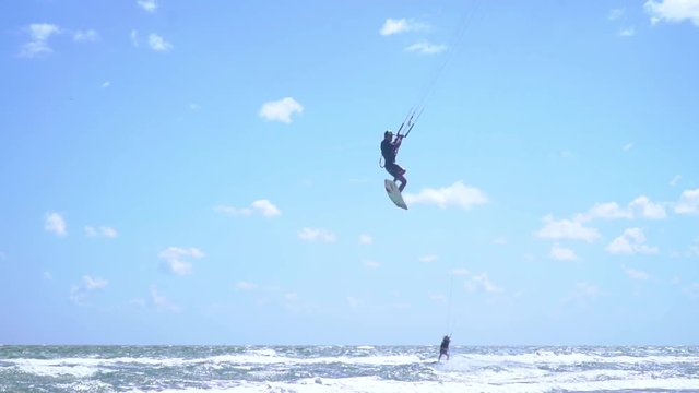 Kitesurfers ride the waves on a summer day