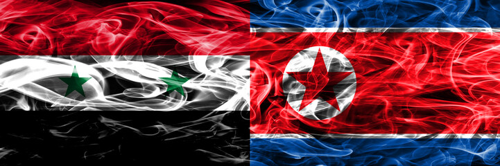 Syria vs North Korea smoke flags placed side by side. Thick colored silky smoke flags of Syrian and North Korea