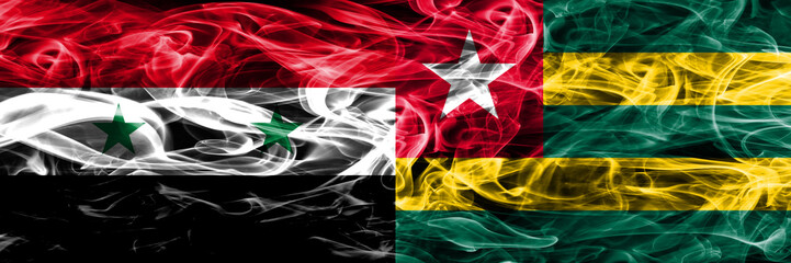 Syria vs Togo smoke flags placed side by side. Thick colored silky smoke flags of Syrian and Togo