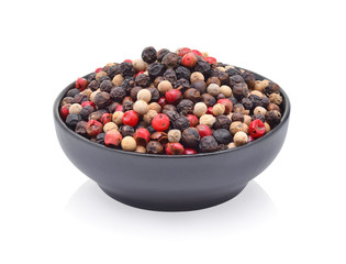 Black, red and white pepper in bowl on white background