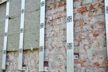 Brick house wall renovation and repair with insulation.