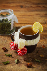 Cup with scarf with hot tea.