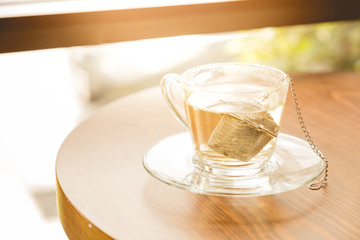 hot tea in glass. a cup of Chinese tea and light in cafe.