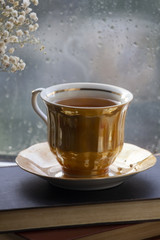 A cup of tea in front of window, autumn mood