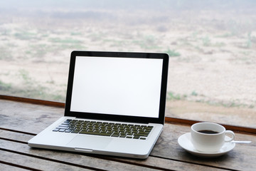 Fototapeta premium Mockup image of laptop with blank white screen on wooden table in terrace nearby river.