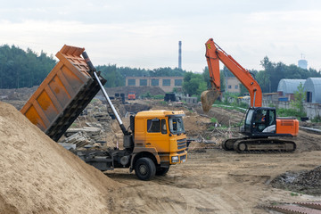 Delivery of sand by truck to the construction site