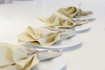 table setting with white plate and a napkin