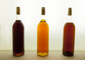 Three bottles of tawny wine with different tones