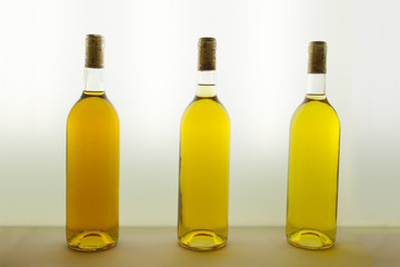 Three bottles of white wine with different tones