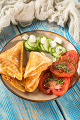 Sandwiches with cheese, tomatoes and cucumber.