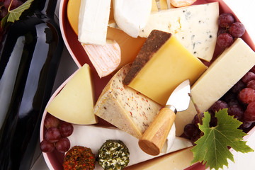 Cheese platter with different cheese and grapes