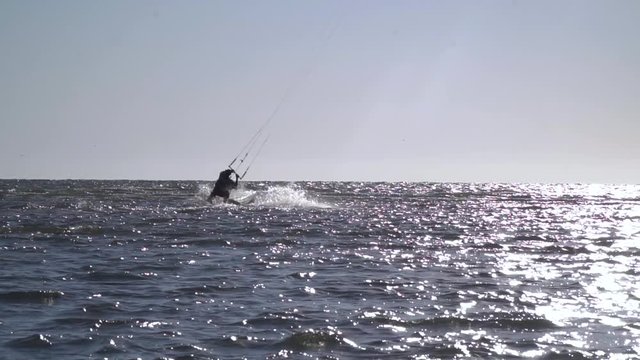 A man is doing a somersault on kitesurf, slow motion