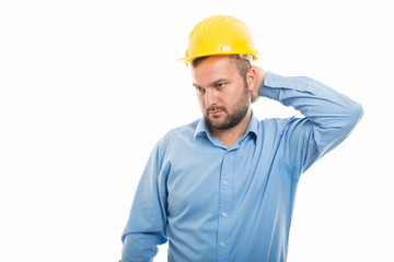 Young architect with yellow helmet showing neck pain gesture