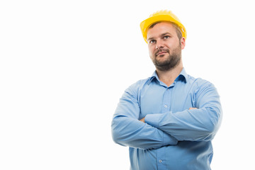 Low angle of young architect standing with arms crossed