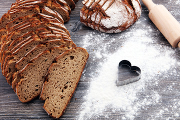 freshly baked bread on wooden board. cutted bread