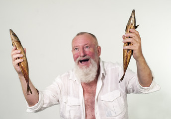 Euphoric fisherman with two fishes in his hands