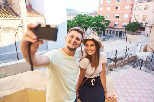 Couple of tourists taking selfie in historical quarter of Spain