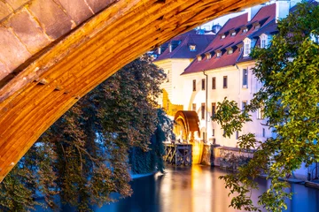 Fotobehang Certovka River and old Water mill under Charles Bridge, Lesser Town of Prague, Czech Republic. © pyty