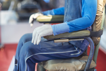 pilot in blue jacket and blue pants fastened to an armchair © Denis Starostin