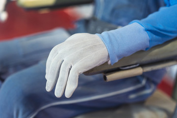 pilot in blue jacket and blue pants fastened to an armchair © Denis Starostin