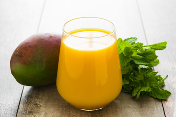 Mango Lassi dessert. Traditional Indian drink on wooden table. Copyspace