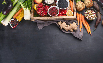 Fresh vegetables and legumes in wooden box.
