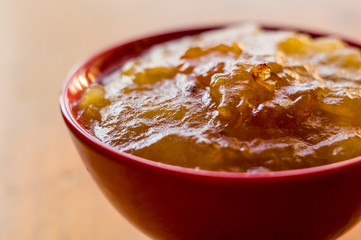 Homemade apple jamTransparent Apple sweet homemade jam in the red ceramic bowl