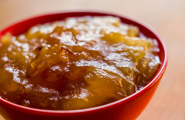 Homemade apple jamTransparent Apple sweet homemade jam in the red ceramic bowl