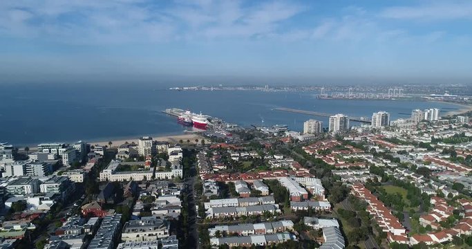 Port Phillip bay in Melbourne around trans tasman ferry wharf and terminal from Port Melbourne residential suburb with local streets.

